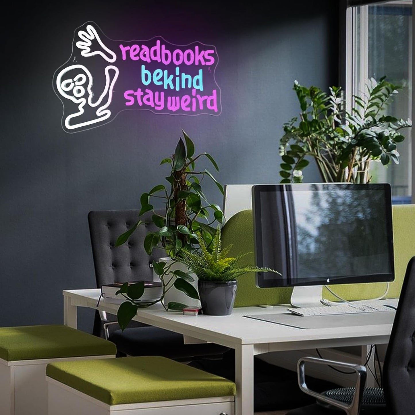 Waving alien neon sign with the phrase "Read Books Be Kind Stay Weird" glowing in LED lights