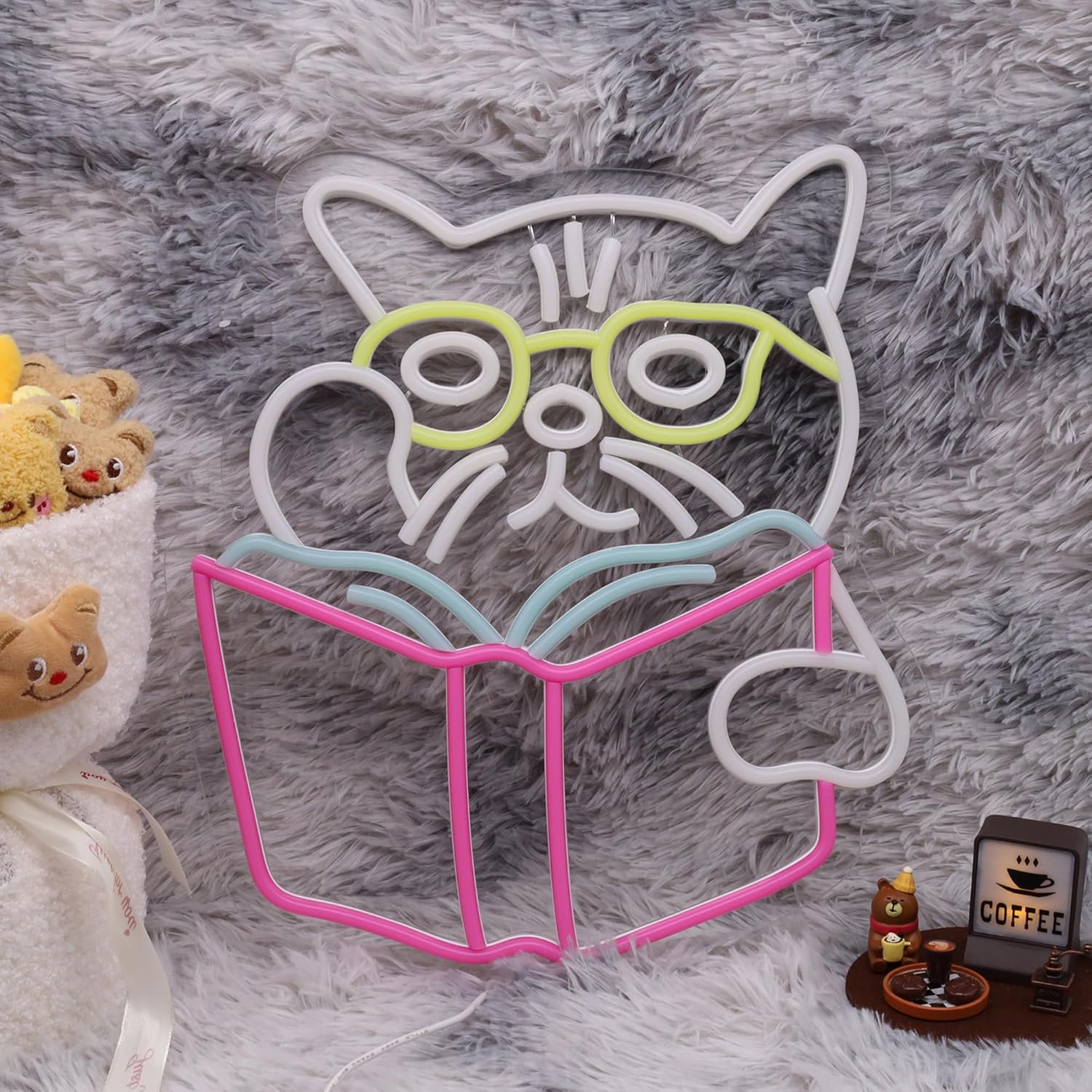 Cat wearing glasses reading a book neon sign