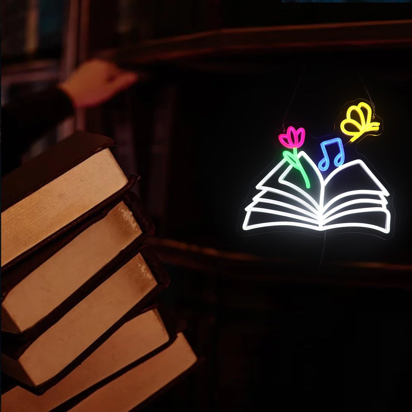 Neon sign of a magical book with glowing butterflies, flowers, and musical notes