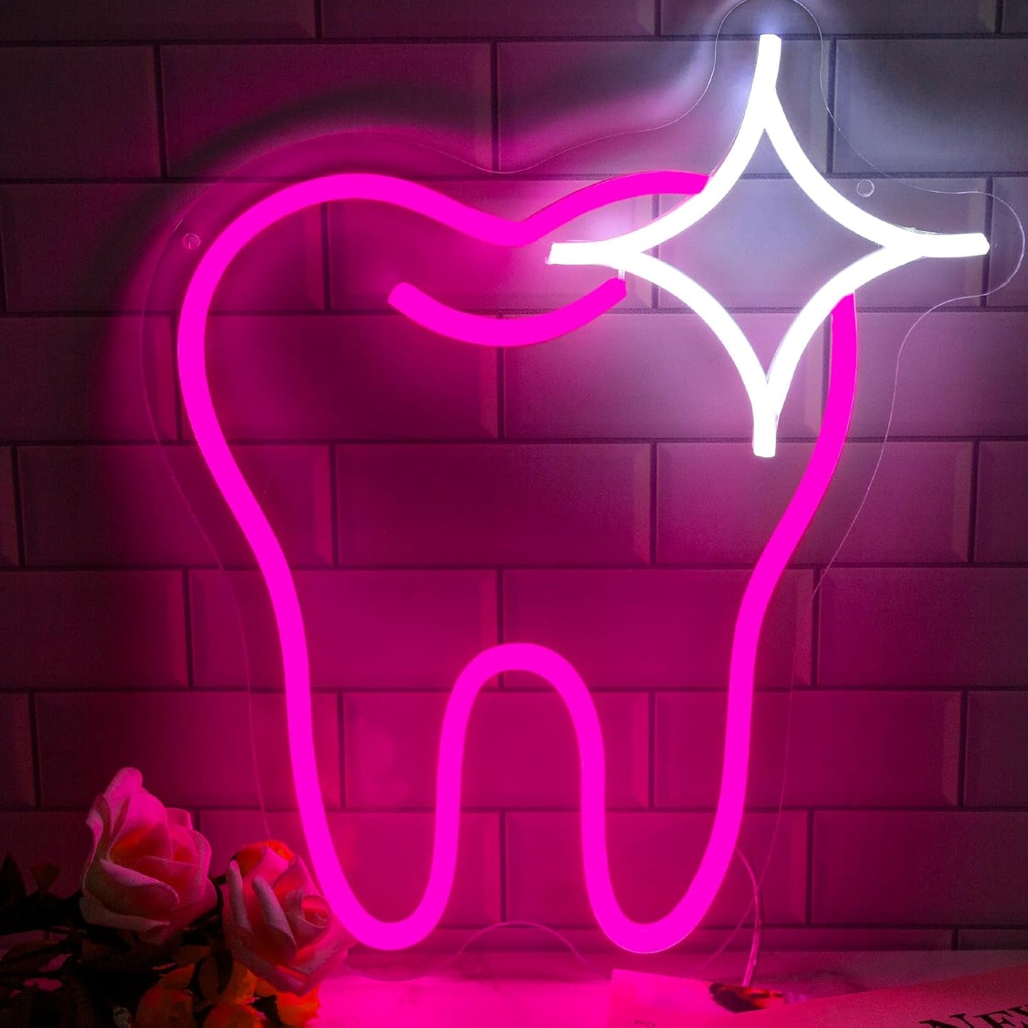 Cute pink neon sign shaped like a tooth, perfect for dental offices or fun home decor