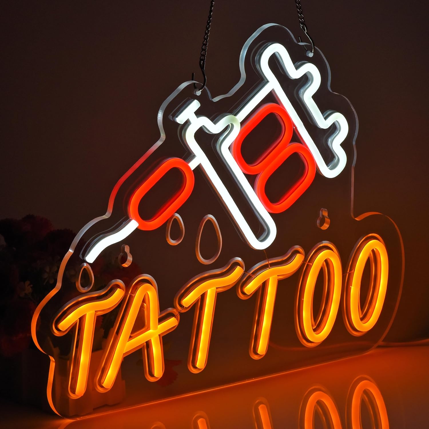 LED tattoo neon sign in red and orange featuring a tattoo machine and dripping ink