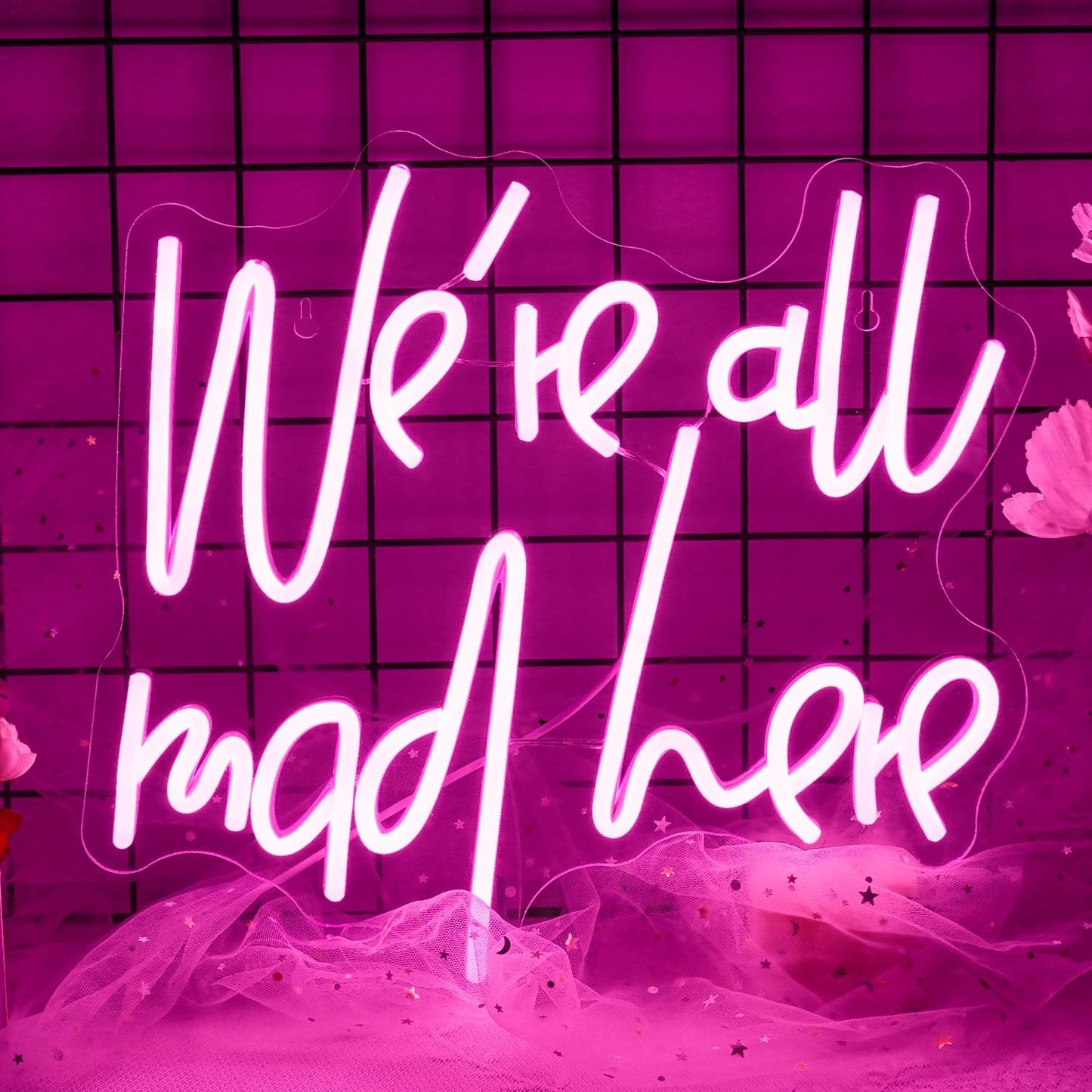 Wonderland-inspired neon sign with quote “We’re all mad here” in glowing LED