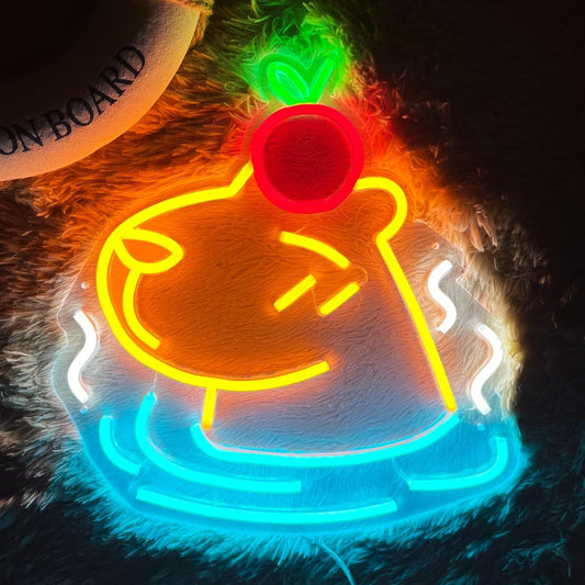 Neon sign of a capybara with a red apple on its head