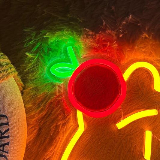 Neon sign of a capybara with a red apple on its head