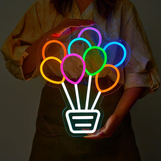 Neon sign of a basket filled with colorful balloons, glowing in LED lights