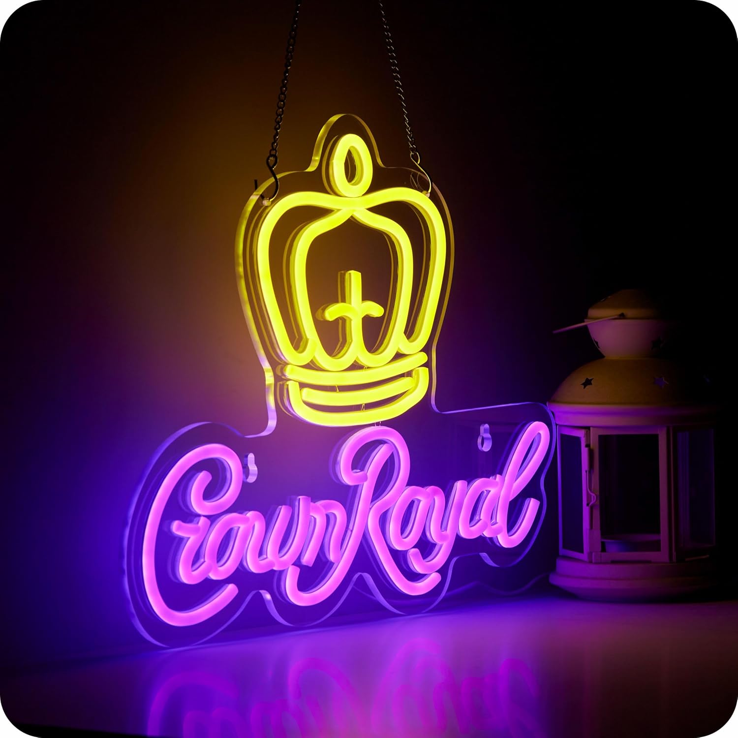 Crown Royal neon sign with yellow crown and purple cursive letters on black wall