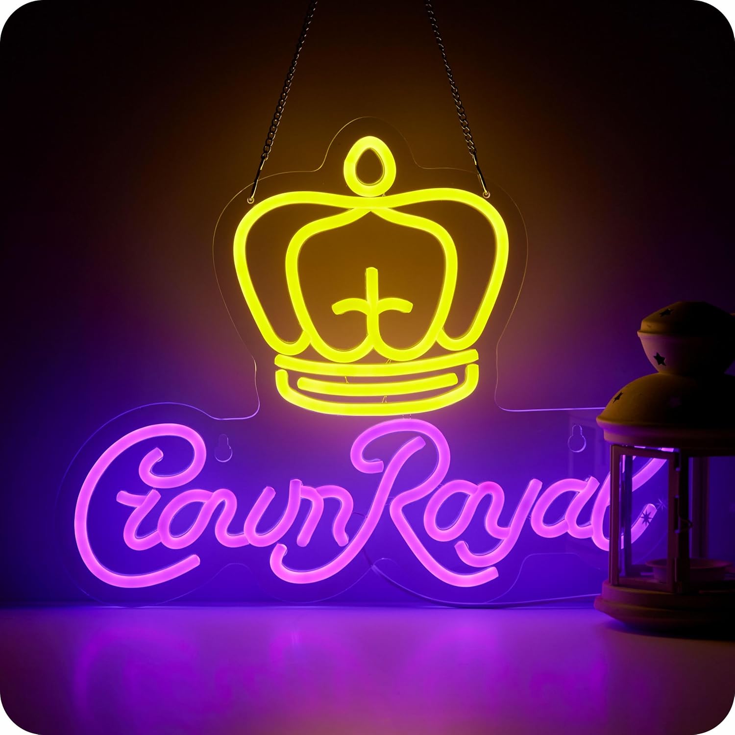 Crown Royal neon sign with yellow crown and purple cursive letters on black wall