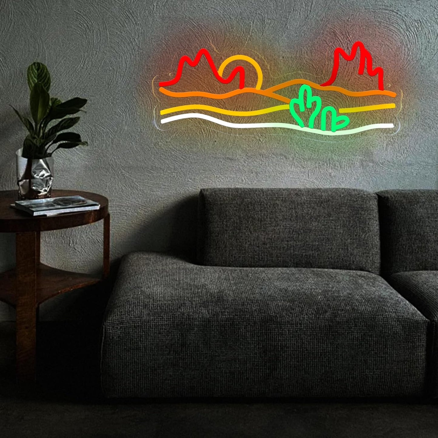 Neon sign of a desert sunset with cacti and mountains