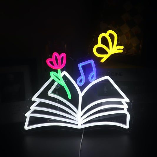 Neon sign of a magical book with glowing butterflies, flowers, and musical notes