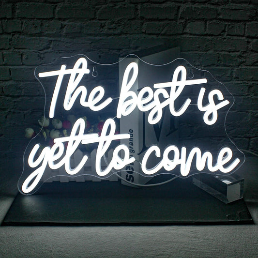 White neon sign that says “The best is yet to come” in cursive script, ideal for weddings, bedrooms, or motivational spaces