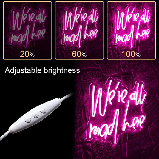 Wonderland-inspired neon sign with quote “We’re all mad here” in glowing LED